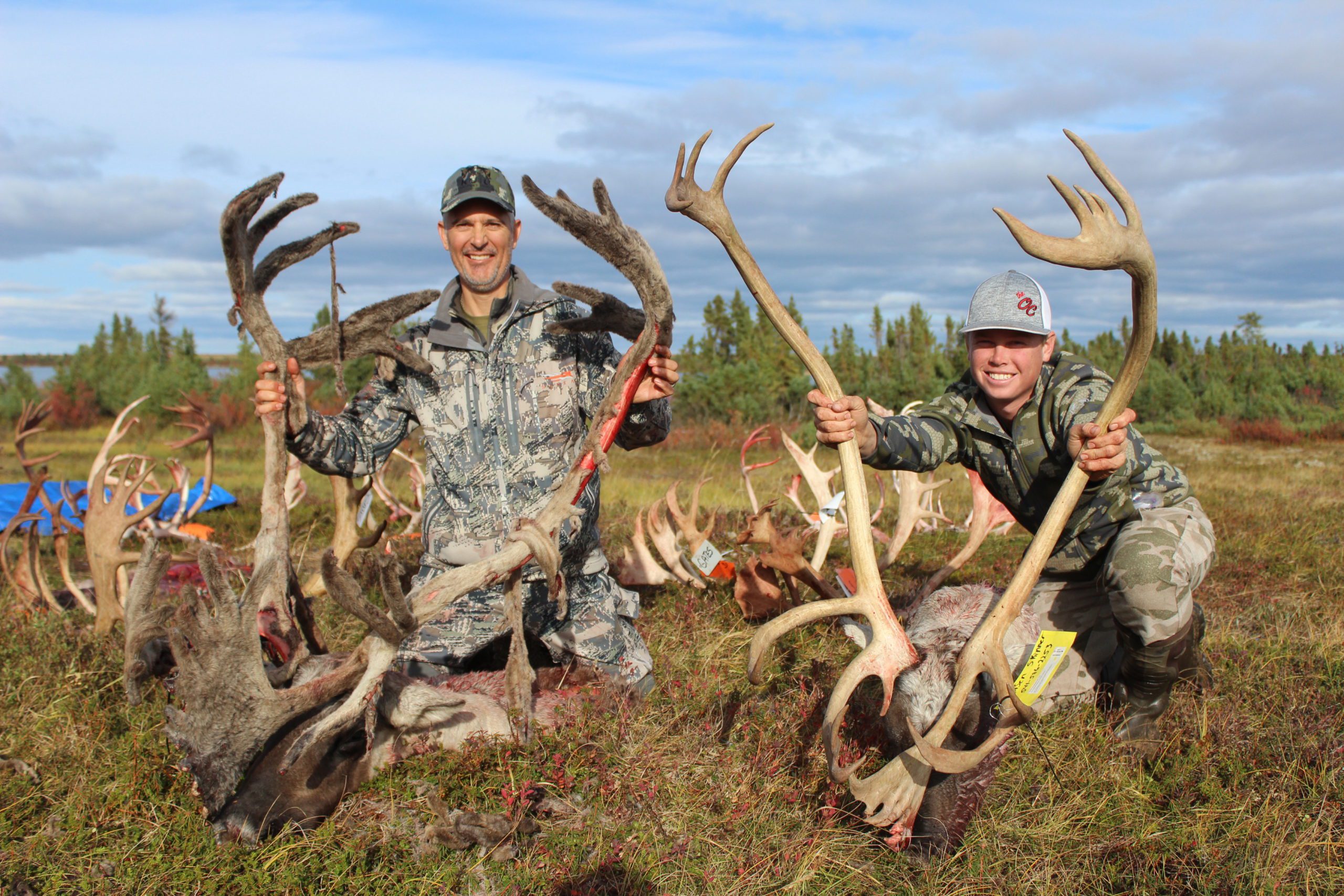 Portrait of Roger Batt and Kassen with 2 dead caribou