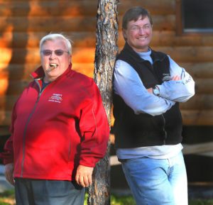 Ken and Wayne Gangler standing against a tree