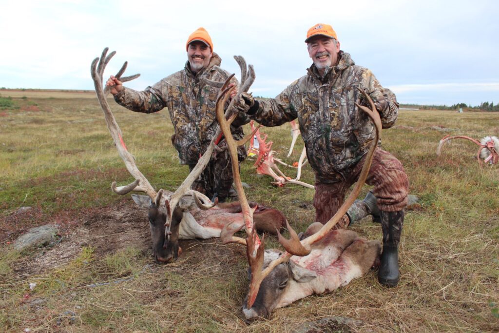 Portrait of Dan and Andrew McCabe with their caribou