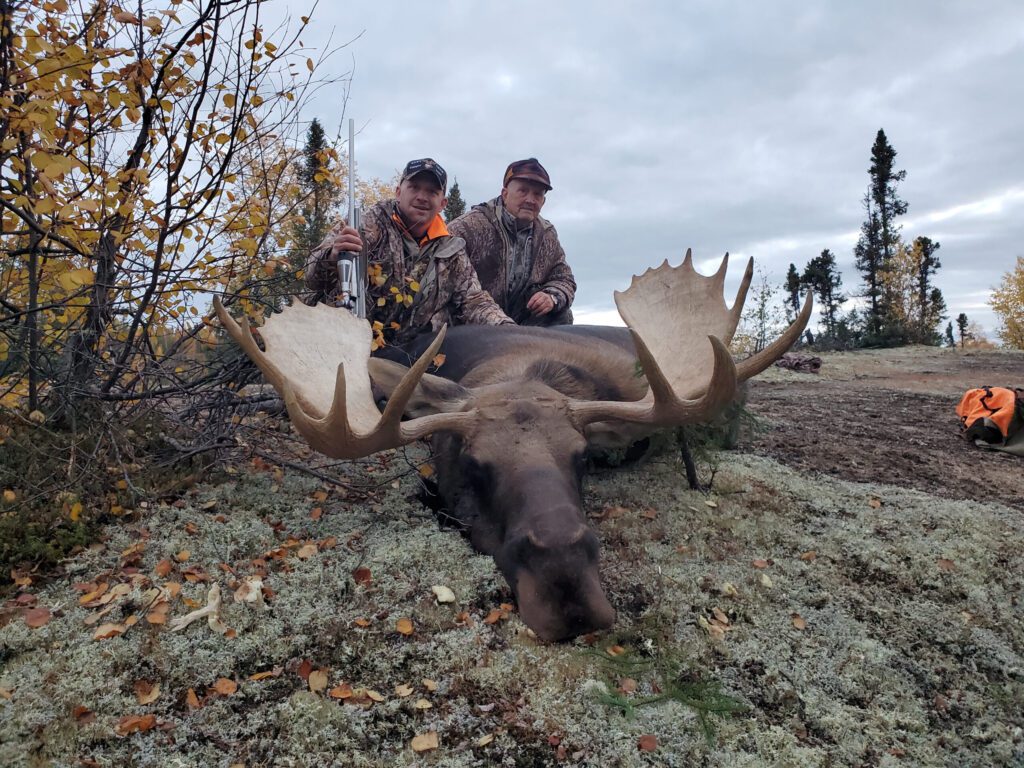 Portrait of Marty and Gene and their moose